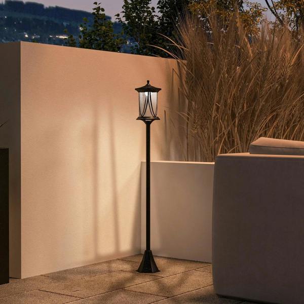 Black solar lamp post light with lantern head and warm light glow