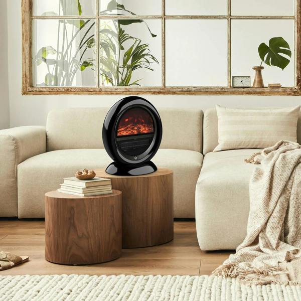 Black electric fireplace heater on a wood side table with flame effect window and mesh grille
