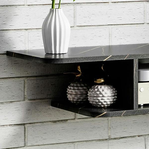 Black floating TV console with open cubby shelves holding decorative items