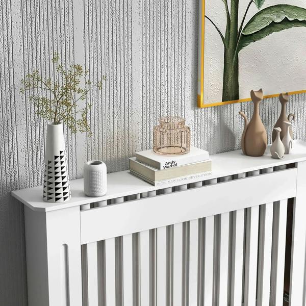 White radiator cover cabinet with top shelf displaying decor and vertical slat grill
