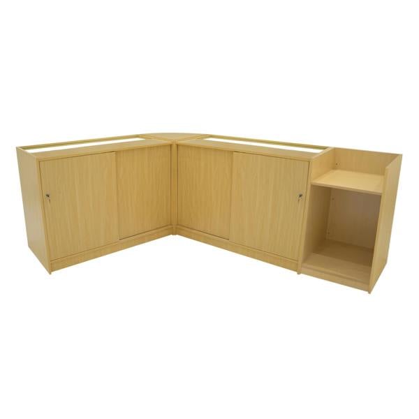 Maple-colored Phoenix LED Shop Counter Set featuring a corner design with two cabinets and an open display shelf for versatile storage