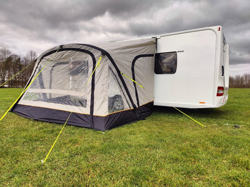 The OLPRO View Lite Breeze 390 Caravan Awning pictured in a Caravan site attached to a caravan.