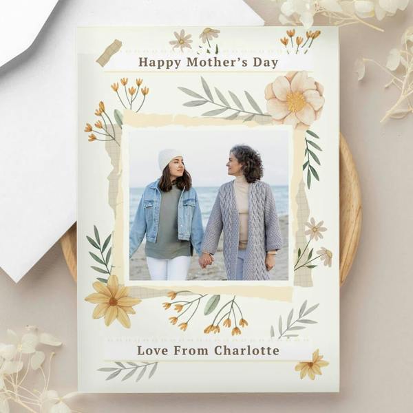 A personalised illustrated wildflower greeting card reading 'Happy Mother's Day' and 'Love From Charlotte' with a uploaded photo of a mother and daughter on a beach.