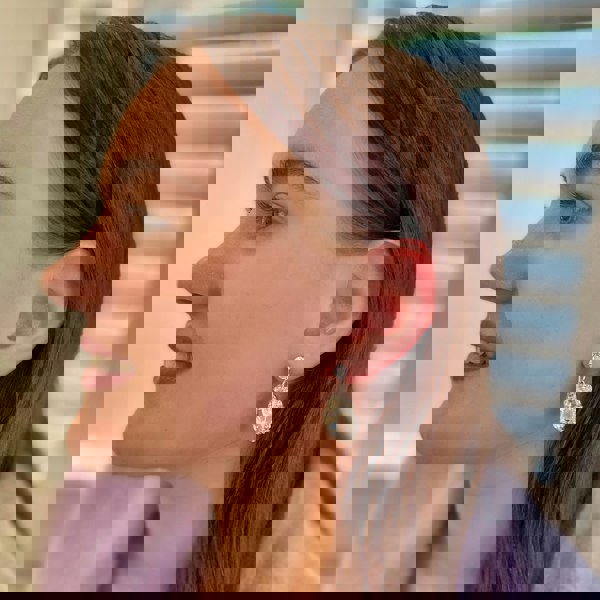 Drop earrings, large teardrop-shaped clear crystals, surrounded by sparkling diamante halo, gold-tone setting, vintage inspired design, elegant statement jewellery
