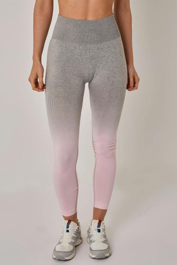 Person wearing gray to pink gradient leggings on a plain background