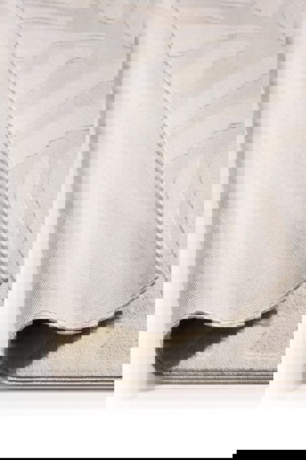 Abstract geometric rug in cream shades, showcasing a soft texture and modern design.