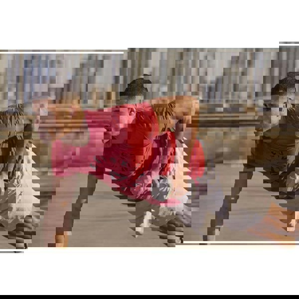 Man exercising outside using Reebok 4kg Dumbbells