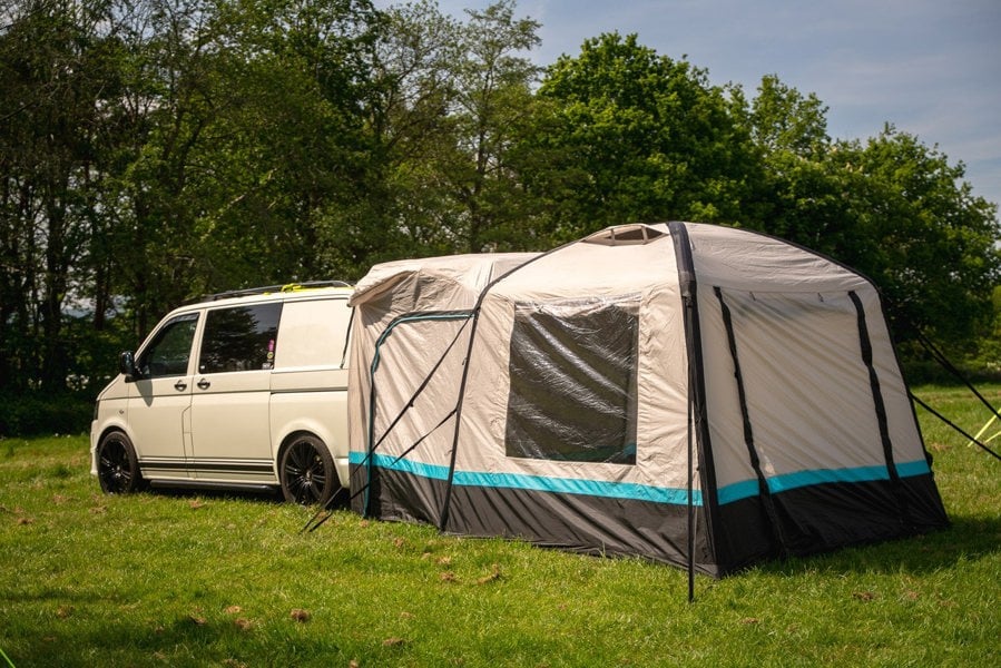 The OLPRO Snug Inflatable campervan Awning attached to the tailgate of a Volkswagen T5 camper