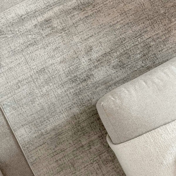 cream and grey rug features an abstract pattern