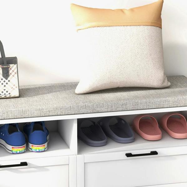 White shoe bench with grey padded seat, open shoe cubbies, and drawer fronts
