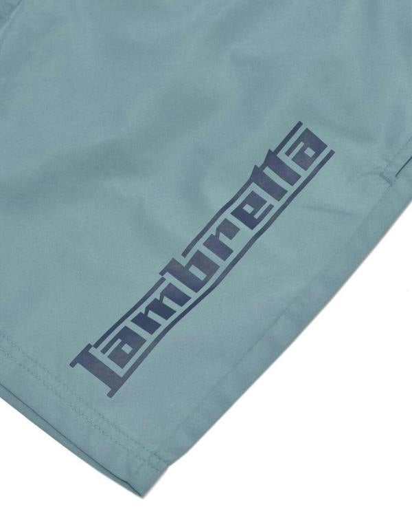 Lambretta Mens Swimming Casual Summer Shorts, light blue swim shorts with a dark blue geometric logo print.
