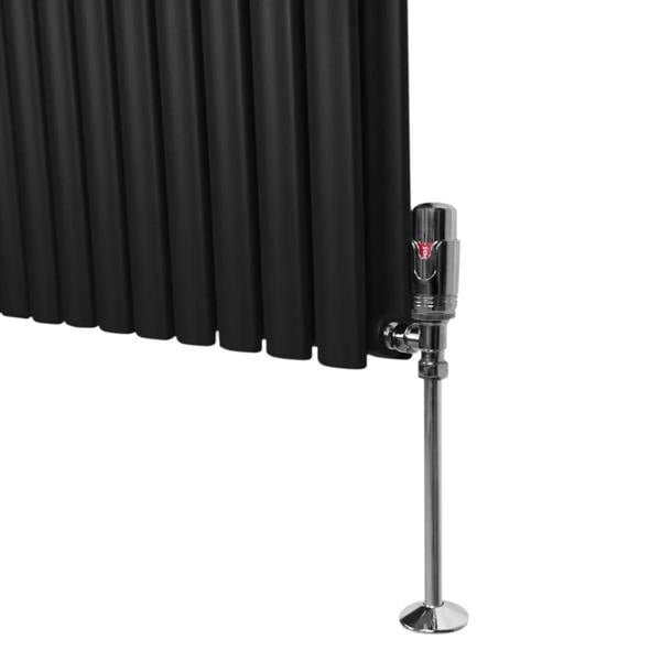 Black oval column radiator with vertical fins and chrome valve, designed for efficient heating in modern interiors