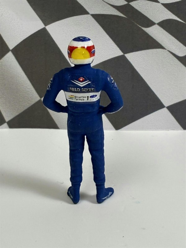a toy figure in a race suit