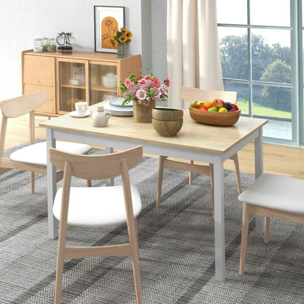 Natural wood dining table with white frame and four matching chairs, room setting