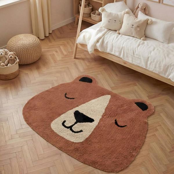 Bear-shaped rug on a wooden floor in a child's bedroom