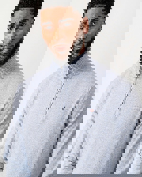 close up of a model wearing a GANT Mens Superfine Lambswool Half Zip Cardigan in Ice Blue Melange