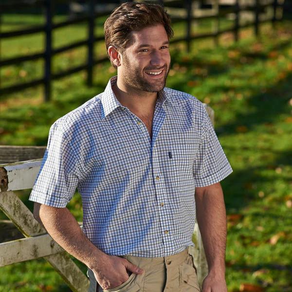 Man wearing Champion blue Tattersall short sleeve shirt outdoors with jeans for a smart-casual look