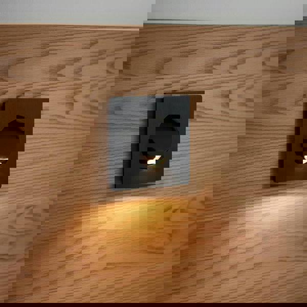 black recessed LED reading lamp for bed recessed into a wooden bed headboard