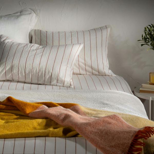 Cinnamon Wool Block Colour Check Throw styled in a bedroom | Soak and Sleep