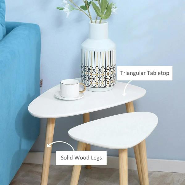 White nesting end tables with rounded tops and solid wood legs beside sofa
