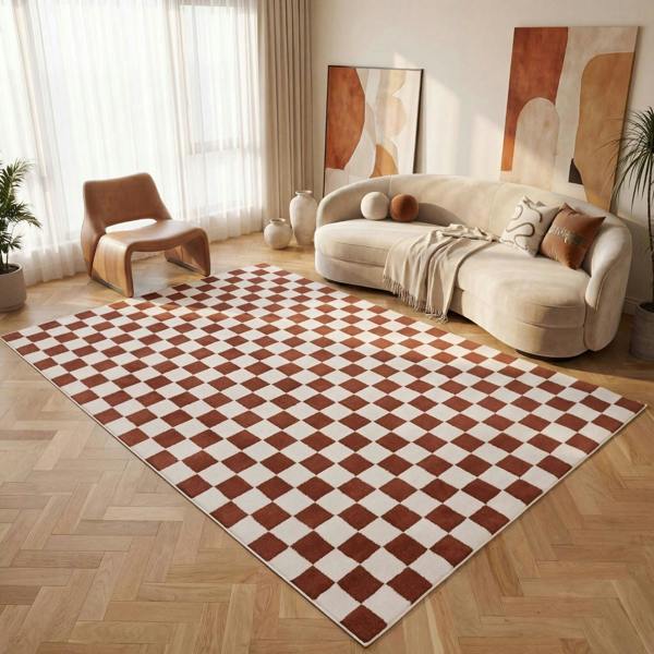 Living room with a checkered rug, beige sofa, and abstract art on the wall.