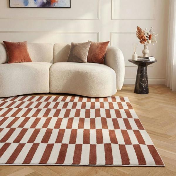 Living room with a checkered rug, beige sofa, and decorative items.