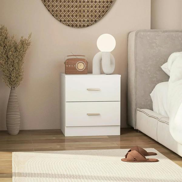 White bedside cabinet with two drawers and metal bar handles, placed beside bed