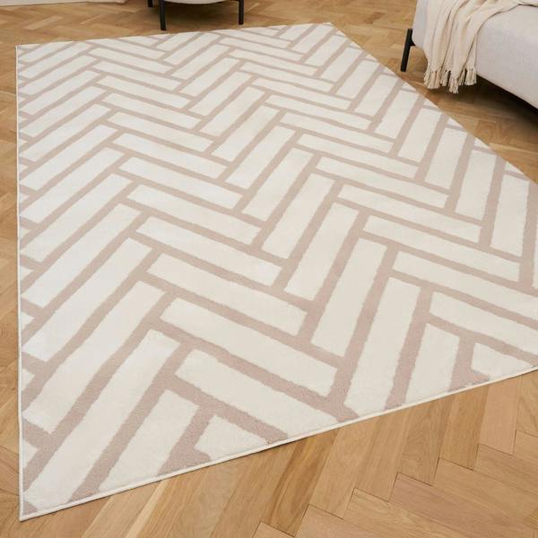 Beige and white geometric patterned rug on a wooden floor