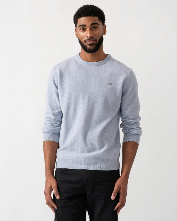 Model wearing a GANT Mens Superfine Lambswool Crew Neck Jumper in Ice Blue Melange