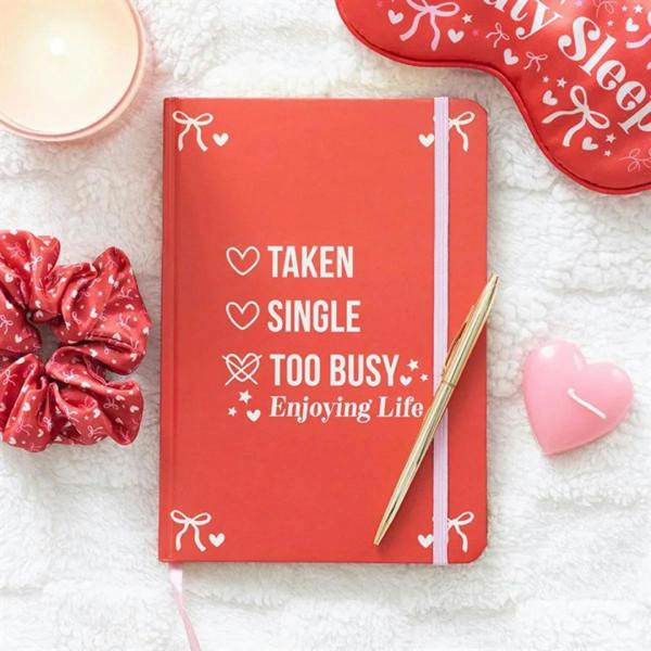 Red A5 notebook with “Taken Single Too Busy Enjoying Life” cover text and bows