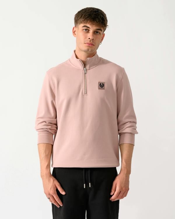 model wearing a Belstaff Mens Logo Quarter Zip Sweatshirt in Dusk Pink
