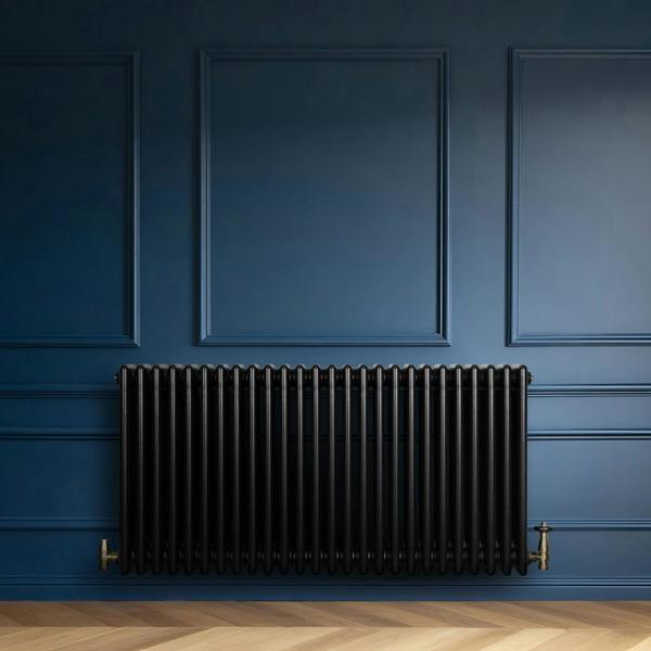 Traditional black 4 column radiator against a deep blue wall, featuring a sleek, glossy finish and elegant design, ideal for classic interiors