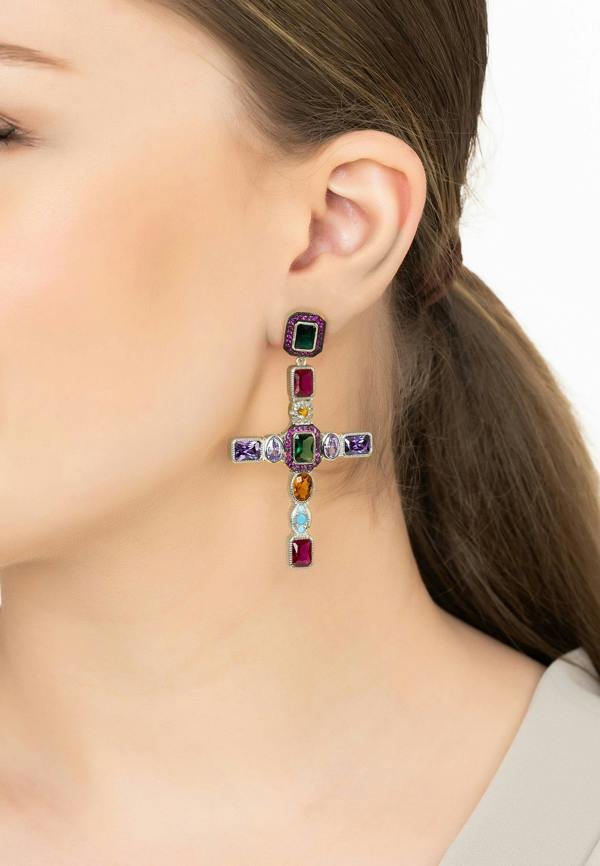 Multicolored gemstone earrings on a model with a neutral background