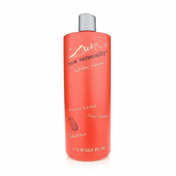 Red shampoo bottle with silver cap on a white background