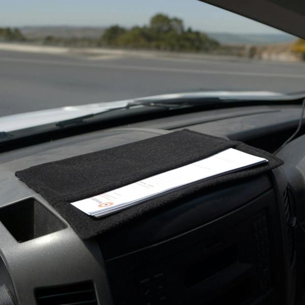 Black storage pouch resting on a car dashboard, featuring a soft texture and flat design, ideal for organizing documents and essentials