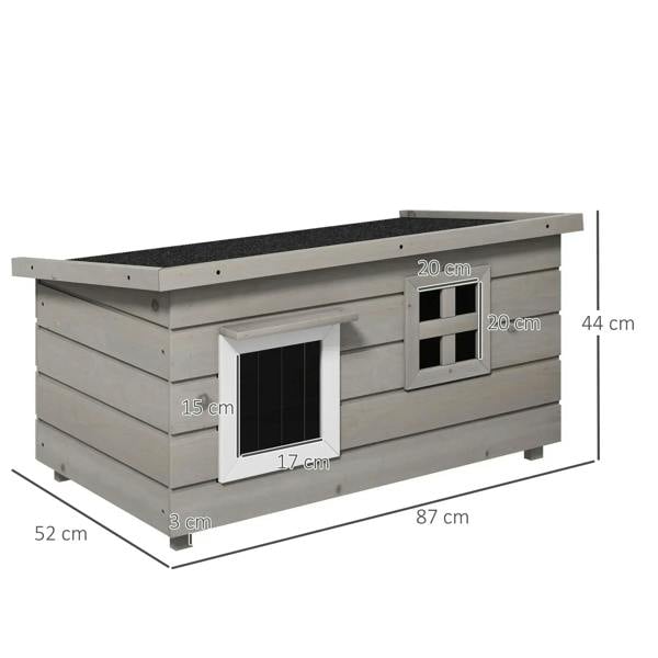 Grey wooden elevated outdoor cat house with two front windows and asphalt roof