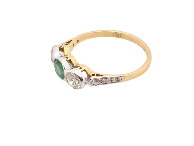 An Emerald and Diamond three stone ring side view