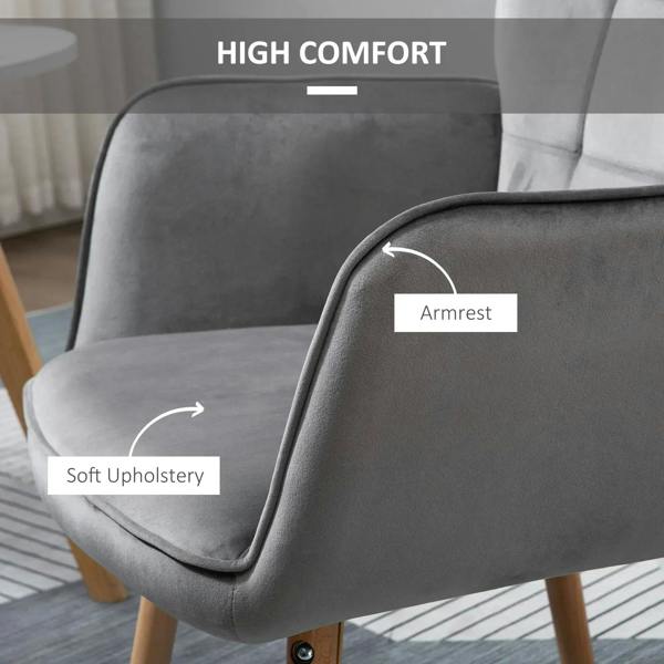 Grey wingback armchair armrest with soft rounded padding and wooden feet