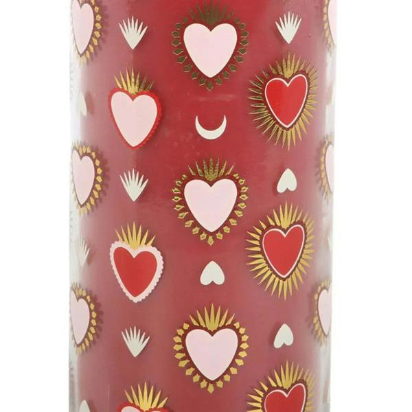 Close-up tube candle sleeve with red background and colorful heart motifs