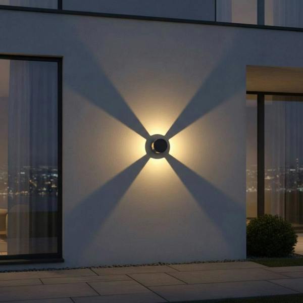 black outside wall light mounted on the exterior wall of a home in between 2 large windows