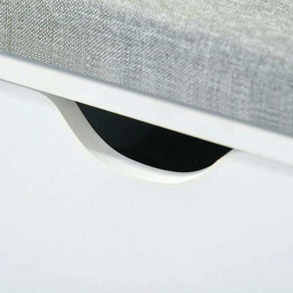 Curved cutout handle under grey cushion on white shoe storage bench