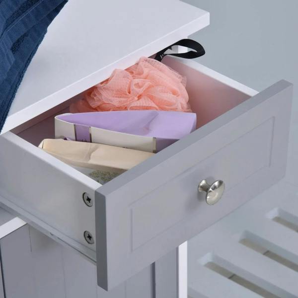Open drawer of white and grey bathroom cabinet with silver knob and stored toiletries