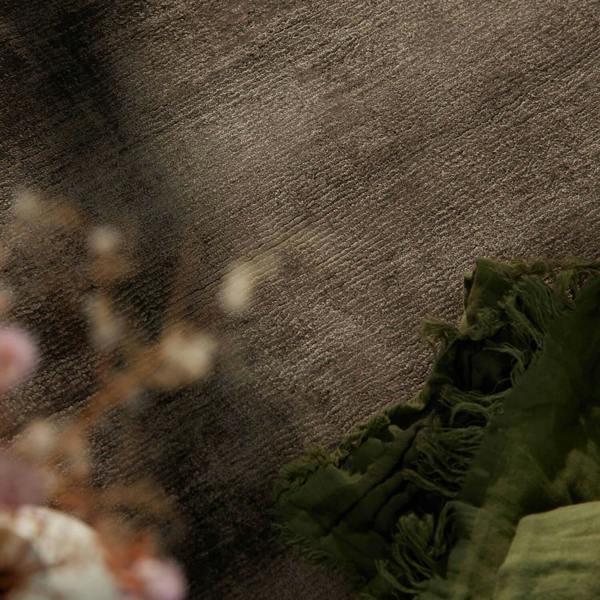 Textured brown wall with green decorative elements