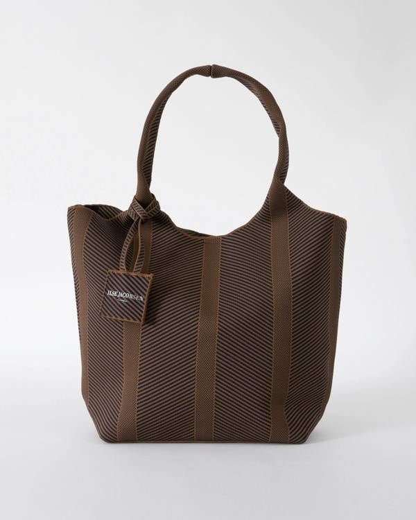 studio shot of Ilse Jacobsen Knitty Womens Knitted Bag in Dark Indigo and Buckthorn Brown