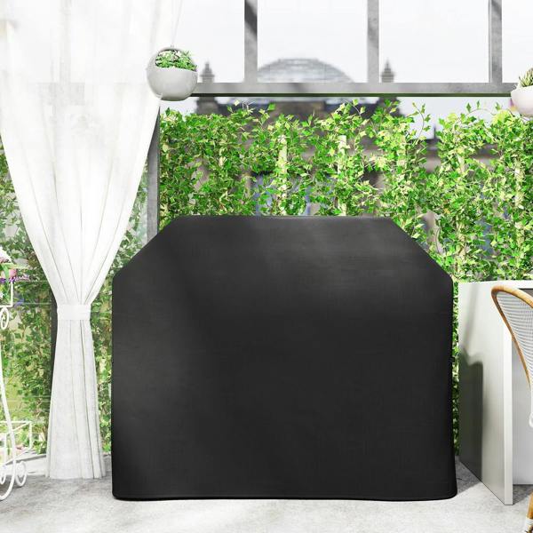 Black fitted protective grill cover on outdoor grill, fully covered top and sides.