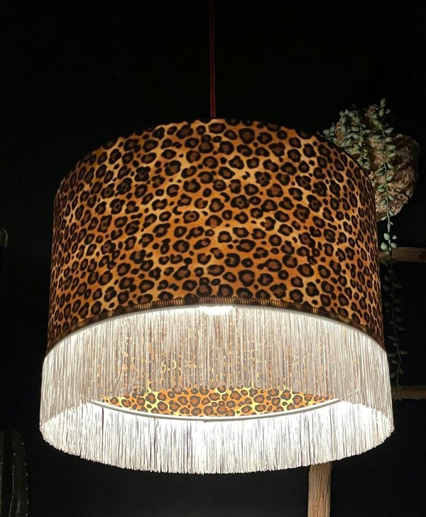 Crisp White Leopard Print Silhouette Lampshade with White Fringing with the light on