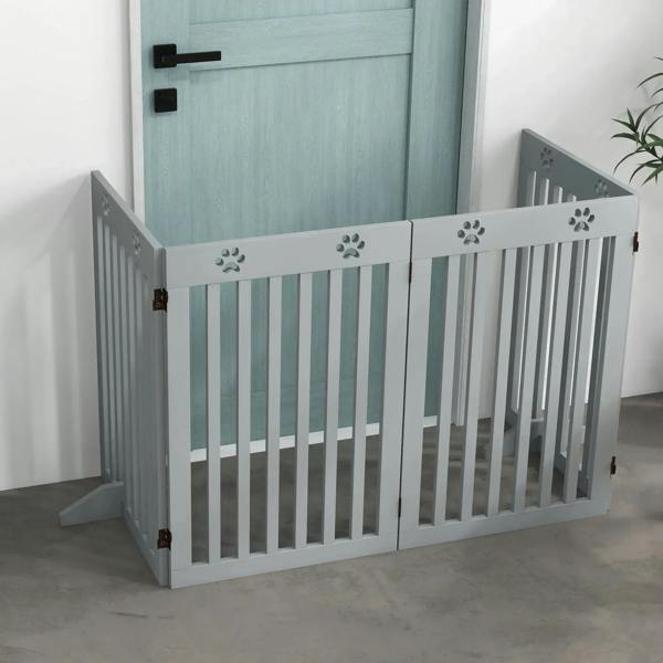 Grey foldable wooden pet gate with paw cutouts, vertical bars, and latch bar