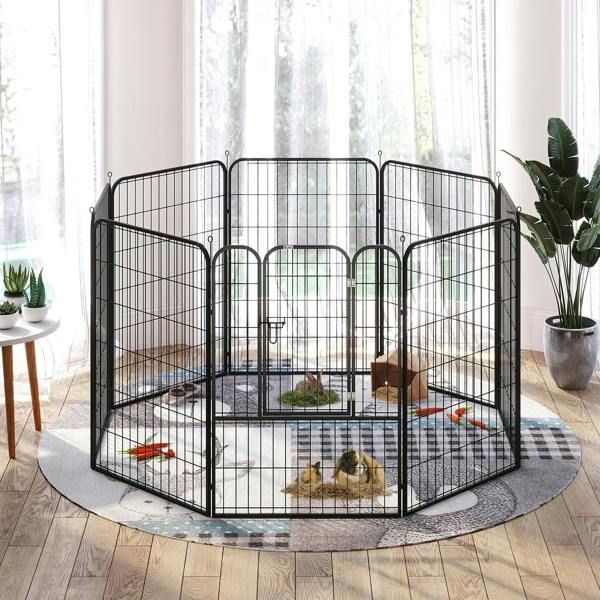 Black metal puppy playpen enclosure with door and small dog resting inside.