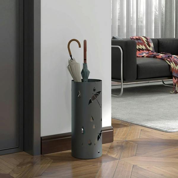 Dark grey cylindrical umbrella stand basket holding umbrellas
