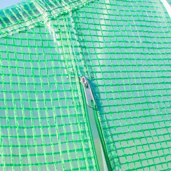 Close-up of green greenhouse mesh fabric with door zipper pull